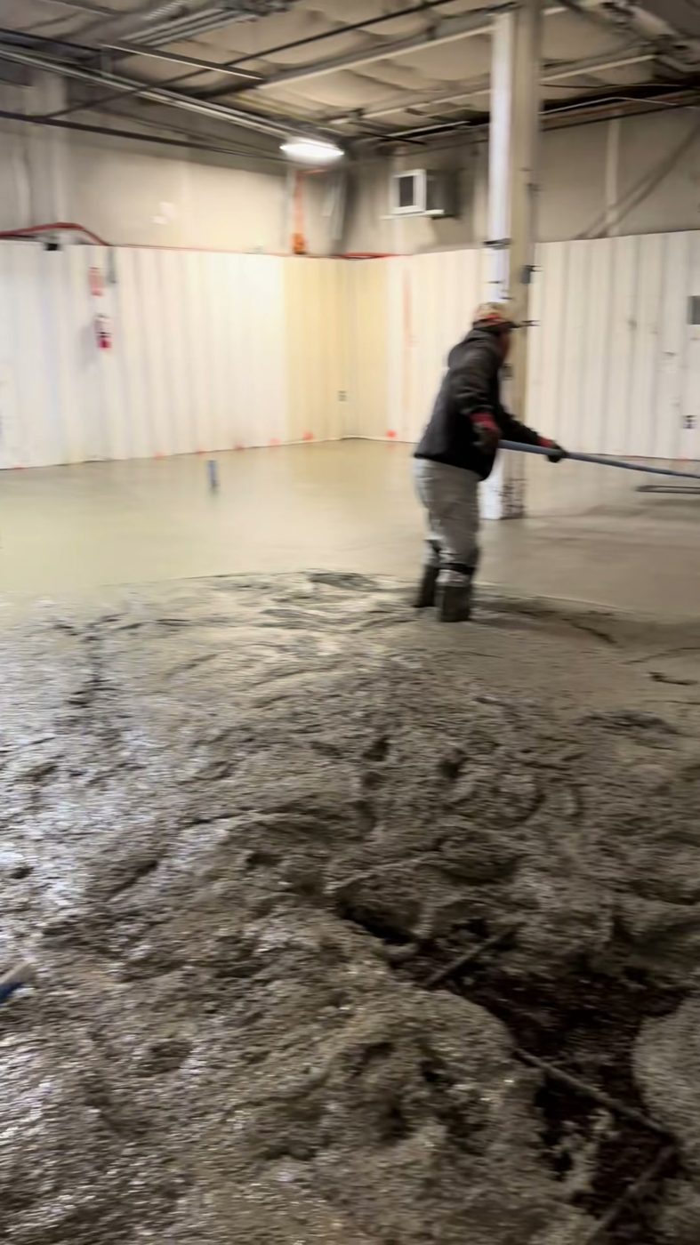 Crew finishing a commercial interior concrete floor